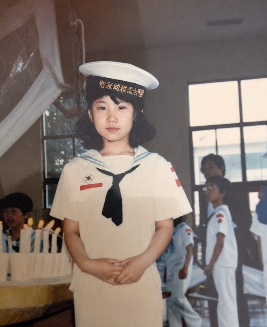 Judy as a young child in a kindergarten sailor uniform and cap